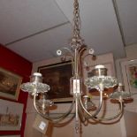 A five branch chromed and glass hanging chandelier