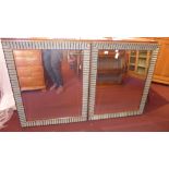 A pair of wall mirrors with rectangular bevelled plates within distressed finish scalloped frames