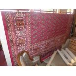 A Bokhara style carpet with repeating gu