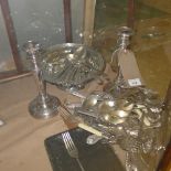 A collection of silver plated items including a pair of silver plated candlesticks and a cased set