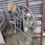 A wrought iron sectional garden mirror