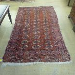 A Bokhara red rug with typical geometric medallion design 
195 cm x 115 cm