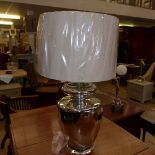 A silvered glass large urn form table lamp with shade