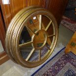 A circular gilt segmented wall hanging mirror