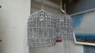 A pair of brass and cut glass bird cage ceiling lights