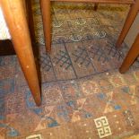 A collection of three rugs including a red ground Belouch and two other Persian rugs