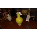Three various table lamps to include a carved wood lamp, a yellow bulbous form ceramic lamp and