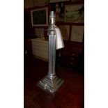 A silver plated corinthium column form table lamp.