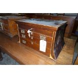 An Edwardian inlaid mahogany cutlery cabinet with hinged top above three drawers