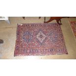 A collection of four rugs to include a Turkoman rug the madder field with central gul enclosed by