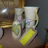 A Clarice Cliff jug with flowerhead detail, a similar beaker (chip to rim) and a similar shaker. (