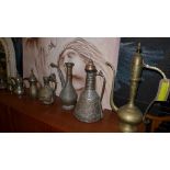 A collection of eight Islamic vessels including a rose sprinkler and coffee pots