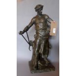 A French spelter statuette of a blacksmith marked 'Le Trevail' and signed