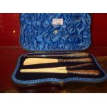 A cased set of late Victorian ivory and hallmarked silver dressing table tools, including a button
