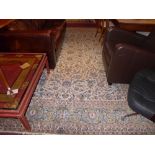 A large carpet the beige field having allover floral motifs and decoration within multi border,