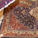 A hand knotted Persian type part silk rug the blue ground with foliate spray decoration.