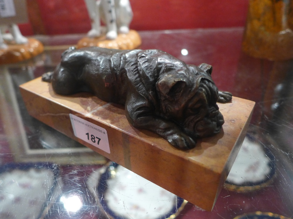 A bronze recumbent bulldog on rouge marble base
