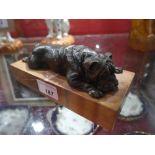 A bronze recumbent bulldog on rouge marble base