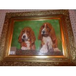 An oil on board depicting two puppy Basset Hounds in gilded frame.