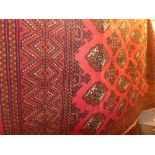 A fine North East Persian Turkoman carpet 270cm x 195cm, repeating goul motifs on a rouge field