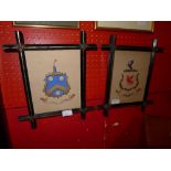 Two C19th hand painted armorial crests in ebonised Oxford frame.