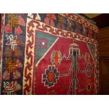 A fine handwoven Persian Shiraz Quasgai the central panel with madder ground and tree of life