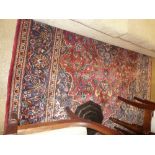 An extremely fine central Persian Kashan carpet 300 cm x 205 cm central pendant medallion on a rouge