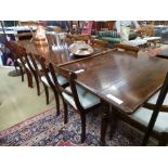 An Arts and Crafts oak framed armchair, with carved detail to back and arm supports on square