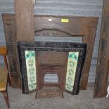 An Arts and Crafts cast iron fire surrounded, in the manner of David Veasey, the two-piece mantel