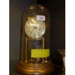 A gilt metal anniversary clock under glass dome