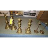 A set of three pairs of brass candlesticks