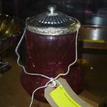 A silver plated and cranberry glass biscuit barrel