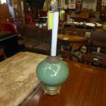 A green glazed bulbous table lamp on gilt base