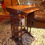 An Edwardian mahogany nest of three tables raised on turned stretchered supports