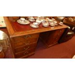 A C19th oak pedestal desk the tooled leather top above an arrangement of drawers.