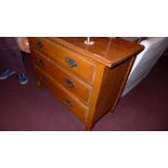 A late Victorian satin walnut chest having three drawers on turned feet