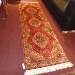 A Kum style runner with three medallions on a red field with spandrels,