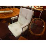 An Eames style high back office chair upholstered in white leather and raised on chromed swivel