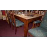 An Art and Craft oak dining table the plank top raised on tapered supports