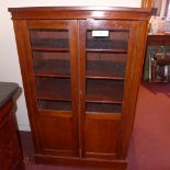 A C19th mahogany bookcase fitted pair of glazed panel doors enclosing adjustable shelves and