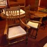 A pair of oak C20th open armchairs with drop in seats on turned supports