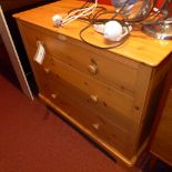 A pine chest fitted three long drawers on plinth base