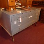 An industrial style metal plan chest fitted four drawers raised on stand