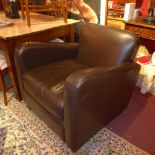 A contemporary brown leather armchair raised on block feet.