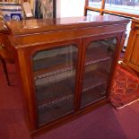 A Victorian walnut bookcase fitted pair of glazed panel doors enclosing shelves and raised on a