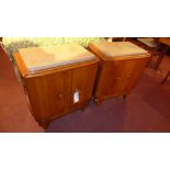 A pair of oak marble top bedside cabinets, each with two cupboard doors.