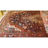 A fine north west Persian wand rug 220cmx125cm central ivory medallion with repeating petal motifs