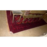 A fine North East Persian Turkoman rug repeating ghoul motives on rouge  field 127cm x 242cm