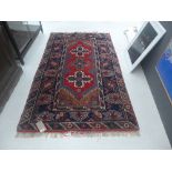 A Persian style rug red ground,