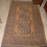 An Afghan rug, having typical gold ground with triple hexagonal motifs to centre, enclosed by